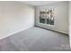 Bright bedroom with new carpet, a large window and neutral tones at 8813 Gerren Ct, Charlotte, NC 28217