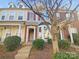 Charming townhome with brick accents, red shutters, and a well-maintained front yard at 8813 Gerren Ct, Charlotte, NC 28217