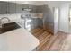 Well-lit kitchen featuring gray cabinets, stainless steel appliances, and tile backsplash at 8813 Gerren Ct, Charlotte, NC 28217