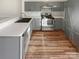 Well-lit kitchen featuring gray cabinets, stainless steel appliances, and tile backsplash at 8813 Gerren Ct, Charlotte, NC 28217