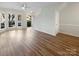 Bright living room featuring hardwood floors and large windows allowing for ample natural light at 8813 Gerren Ct, Charlotte, NC 28217