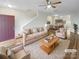 Spacious living room with modern furniture, including a plush sofa and chairs at 8813 Gerren Ct, Charlotte, NC 28217