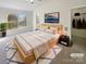 Serene main bedroom features large window, tv, walk-in closet, and neutral tones at 8813 Gerren Ct, Charlotte, NC 28217
