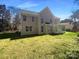 View of backyard with lawn and sunroom of two-story home with gray siding and many windows at 1000 High Brook Dr, Waxhaw, NC 28173