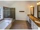 Bathroom features a soaking tub, shower, and double sink vanity with granite countertops at 1000 High Brook Dr, Waxhaw, NC 28173