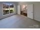 Bright bedroom with a view of the backyard and a doorway that leads into another room with staircase at 1000 High Brook Dr, Waxhaw, NC 28173