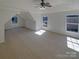 Spacious bedroom boasts three windows, neutral carpet, and a stylish ceiling fan at 1000 High Brook Dr, Waxhaw, NC 28173