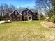 Charming two-story brick home with a well-manicured lawn and classic architectural details at 1000 High Brook Dr, Waxhaw, NC 28173
