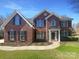 Beautiful brick home with a manicured lawn, enhanced by a pathway and garden bed at the home's entry at 1000 High Brook Dr, Waxhaw, NC 28173