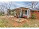 Enclosed patio with stone floor and seating outside of brick home at 107 Destiny Ln, Shelby, NC 28150