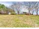 Expansive backyard with mature trees and accessory buildings, offering privacy and space at 107 Destiny Ln, Shelby, NC 28150