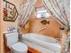Bathroom with bathtub and shower featuring a decorative ocean themed motif at 107 Destiny Ln, Shelby, NC 28150