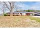 Charming brick home with a well-maintained front yard and mature trees, featuring a carport at 107 Destiny Ln, Shelby, NC 28150