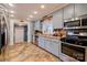 Charming kitchen features stainless appliances, patterned backsplash, and views to adjacent rooms at 107 Destiny Ln, Shelby, NC 28150