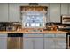 Kitchen sink and stainless dishwasher with a view to the adjacent dining room at 107 Destiny Ln, Shelby, NC 28150
