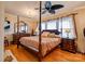Bright main bedroom with wood floors, four poster bed, and a ceiling fan at 107 Destiny Ln, Shelby, NC 28150