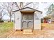 Storage shed in the backyard with double doors and decorative accents at 107 Destiny Ln, Shelby, NC 28150