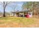 Backyard shed with storage area, tool rack, and lawn equipment at 107 Destiny Ln, Shelby, NC 28150