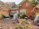 Serene backyard featuring a brick patio with seating, lush plants, and privacy fencing, perfect for relaxation at 1141 Hollyheath Ln, Charlotte, NC 28209