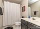 Well-lit bathroom with a vanity, shower, and neutral tones, enhanced by a framed artistic print at 1141 Hollyheath Ln, Charlotte, NC 28209