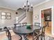 The dining room boasts elegant lighting and easy access to a cozy staircase and gourmet kitchen at 1141 Hollyheath Ln, Charlotte, NC 28209