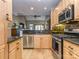 The kitchen features stainless steel appliances, granite countertops, and wood cabinetry at 1141 Hollyheath Ln, Charlotte, NC 28209