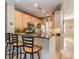 Gourmet kitchen with bar seating, granite countertops, stainless steel appliances and hardwood floors at 1141 Hollyheath Ln, Charlotte, NC 28209
