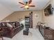 Cozy living room featuring a leather sofa, ceiling fan, media center, and sloped ceilings at 1141 Hollyheath Ln, Charlotte, NC 28209