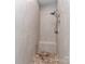 Luxurious walk-in shower featuring stylish tilework, a built-in bench, and rainfall shower head at 1141 Hollyheath Ln, Charlotte, NC 28209