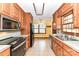 Functional kitchen featuring wood cabinets and ample countertop space for meal preparation at 117 Gwyn St, Wingate, NC 28174