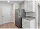 Well-lit kitchen area with granite countertops, white cabinets, and a stainless steel refrigerator at 117 Lightning Dr, Shelby, NC 28152