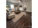 Well-lit living room featuring neutral furniture, dark wood floors, and modern art at 1224 Hollywood Ter, Albemarle, NC 28001