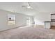Bright living room with carpeted floors, ceiling fan, lots of natural light and open floorplan at 123 Lightning Dr, Shelby, NC 28152