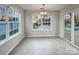 Sunlit dining area with tile floors and views of the backyard pool at 12308 Ridge Cove Cir, Charlotte, NC 28273