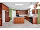 Spacious kitchen featuring dark wood cabinets, a central island, and modern appliances at 14333 Maclauren Ln, Huntersville, NC 28078