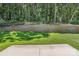 Landscaped backyard view featuring a retaining wall and beautiful, lush green landscaping at 149 Prestwick Way # 39, Mooresville, NC 28115