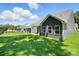 Beautiful backyard view of the new construction home featuring lush green grass and a covered patio area at 149 Prestwick Way # 39, Mooresville, NC 28115