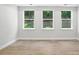 Bedroom with natural lighting, hardwood flooring, and a view of the backyard at 149 Prestwick Way # 39, Mooresville, NC 28115