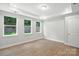 Bedroom with tray ceiling, three windows offering a view, and wood-look flooring at 149 Prestwick Way # 39, Mooresville, NC 28115