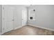 Neutral bedroom with wood-look flooring, bright window, and white doors at 149 Prestwick Way # 39, Mooresville, NC 28115