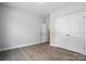 Spacious bedroom with wood-look flooring, neutral walls, and a closet for storage at 149 Prestwick Way # 39, Mooresville, NC 28115