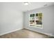 Bright bedroom with a large window allowing natural light and wood-look flooring at 149 Prestwick Way # 39, Mooresville, NC 28115
