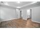 Spacious bedroom with tray ceilings, hardwood floors, and an ensuite bathroom at 149 Prestwick Way # 39, Mooresville, NC 28115
