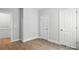 Neutral bedroom featuring two white doors and wood-look flooring at 149 Prestwick Way # 39, Mooresville, NC 28115