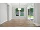 Open dining room with hardwood floors, modern lighting and view to the back yard at 149 Prestwick Way # 39, Mooresville, NC 28115