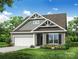 Charming new construction home featuring a two-car garage, manicured lawn, and craftsman-style details at 149 Prestwick Way # 39, Mooresville, NC 28115