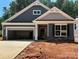 New construction home featuring a two-car garage, stone accents, and stylish gray siding at 149 Prestwick Way # 39, Mooresville, NC 28115