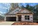 New construction home showing exterior framing, sheathing, and garage awaiting finishing touches at 149 Prestwick Way # 39, Mooresville, NC 28115