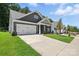 Attractive single-story home with a two-car garage, well-manicured lawn, and inviting curb appeal at 149 Prestwick Way # 39, Mooresville, NC 28115