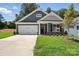 Charming single-story home featuring a two-car garage and landscaped front yard with available sign at 149 Prestwick Way # 39, Mooresville, NC 28115